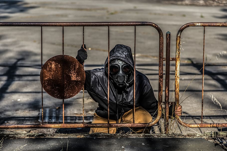 Stalker emerges from a manhole around Chernobyl