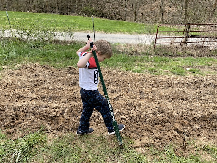 Child working ground with broadfork