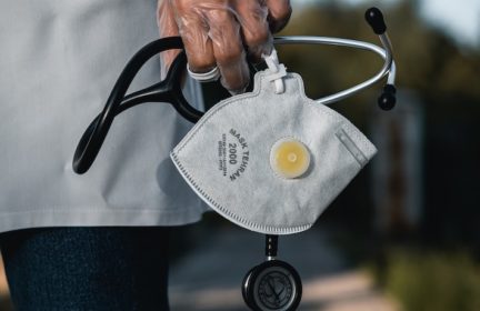 A doctor holding a stethoscope and respirator