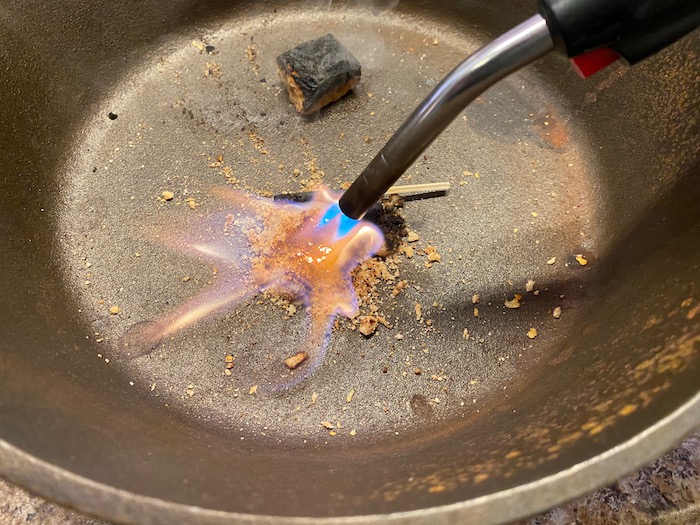 Burning ration block crumbles with a torch