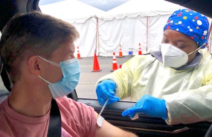 Healthcare worker injecting a man with a vaccine