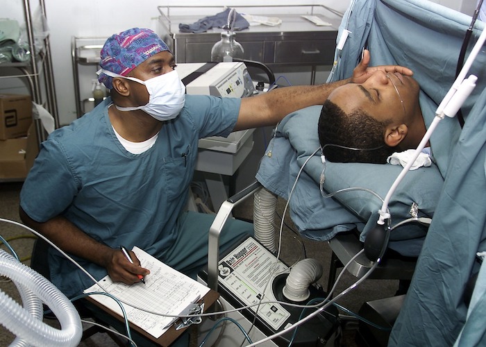 Doctor checking a patient in a bed