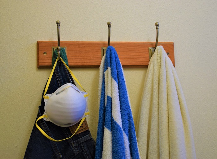 N95 mask on a hook along with jeans and towels