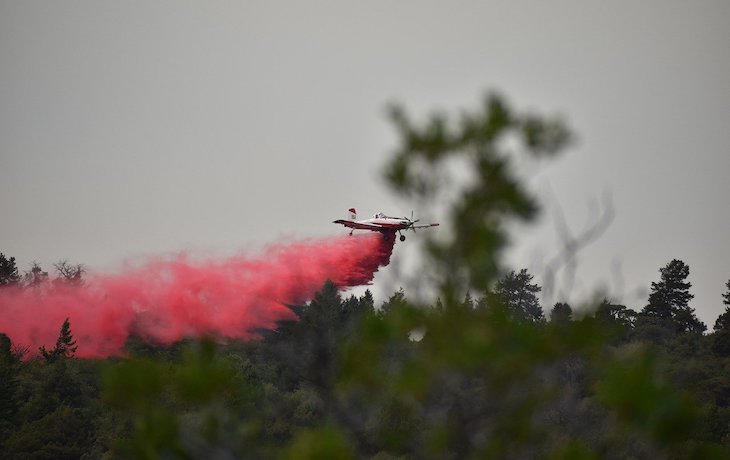 Plane spraying fire retardant.