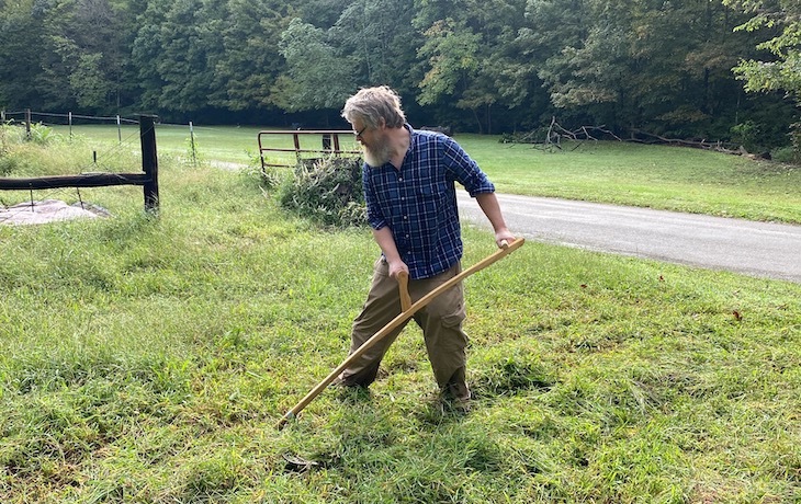 The author scything his yard